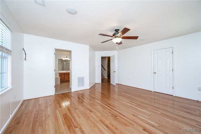 Empty room featuring light wood-style flooring and ceiling fan | Image 21