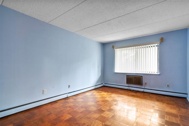 Spare room with a textured ceiling and a baseboard radiator | Image 17