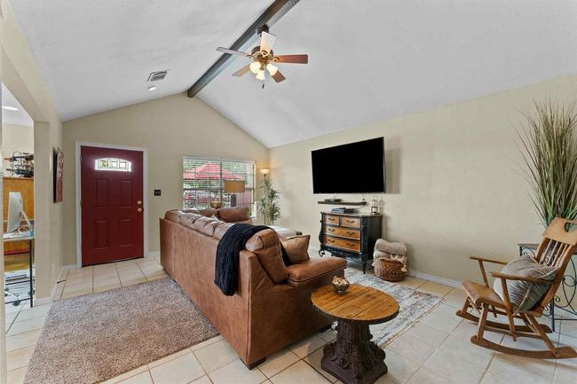 Soaring ceilings and a dramatic architectural beam define this stunning living room, offering both style and space for everyday living or entertaining. | Image 5