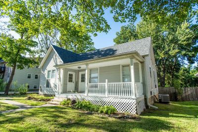 Bungalow-style house featuring cooling unit, a front lawn, and covered porch | Image 3