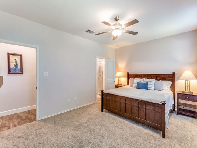 Bedroom with light colored carpet and ceiling fan | Image 19