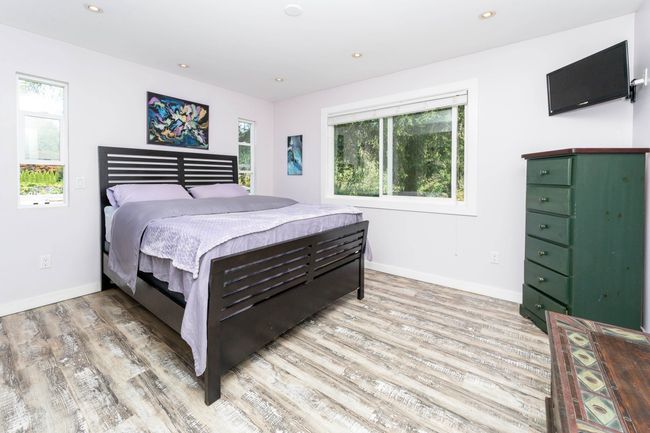 Bedroom with light wood-type flooring, baseboards, and recessed lighting | Image 14