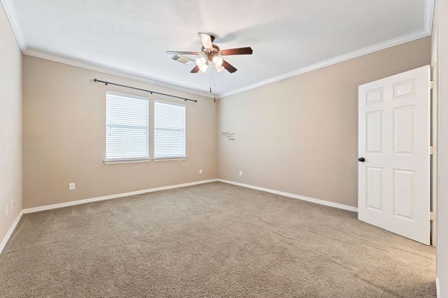 Primary bedroom with ceiling fan | Image 21