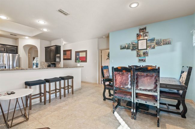 Dining room with visible vents, arched walkways, and recessed lighting | Image 18