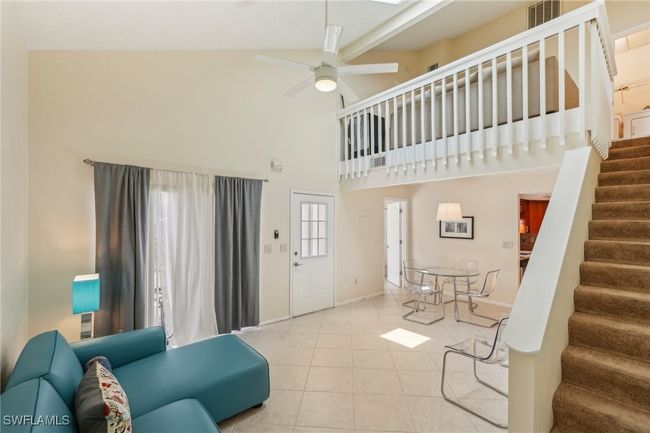 Living area featuring stairs, a towering ceiling, ceiling fan, and tile patterned flooring | Image 10