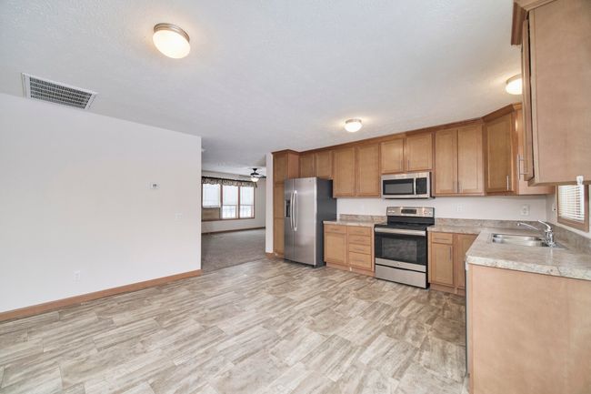 Kitchen opening to living room | Image 12