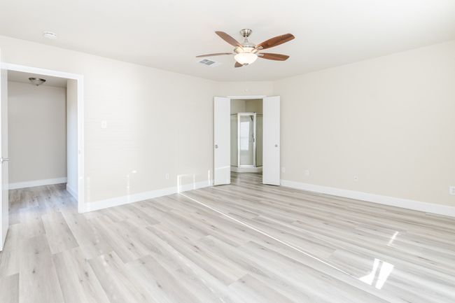 Unfurnished room with ceiling fan, light wood finished floors, visible vents, and baseboards | Image 14