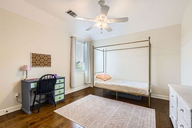 Upstairs bedroom with hardwood floor and ceiling fan | Image 18