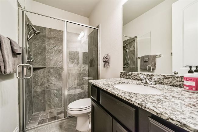 The en-suite bathroom serving the first floor bedroom. nice walk-in shower and ample counterspace. | Image 4