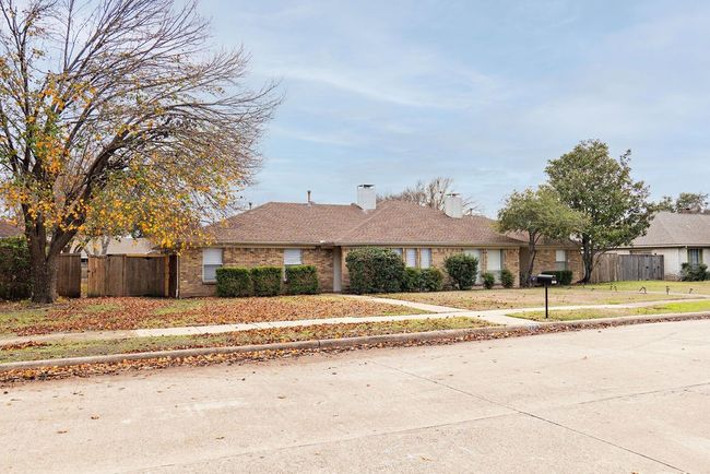 Ranch-style house with brick siding and a chimney | Image 4