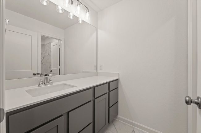 Bathroom with vanity and marble finish floors | Image 22