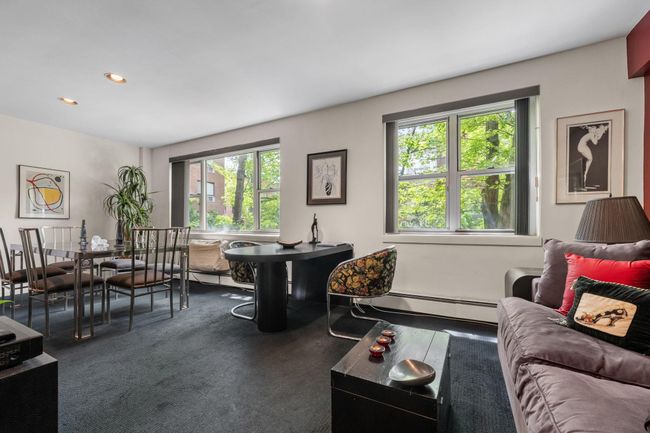 Carpeted living area featuring baseboard heating, plenty of natural light, and recessed lighting | Image 4