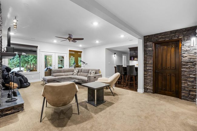 Living room with recessed lighting, carpet floors, a ceiling fan, baseboards, and french doors | Image 22