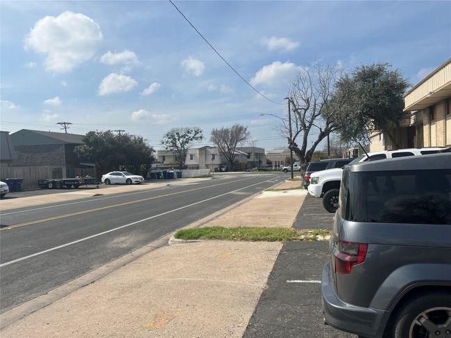View of road featuring curbs, street lighting, sidewalks, and a residential view | Image 20