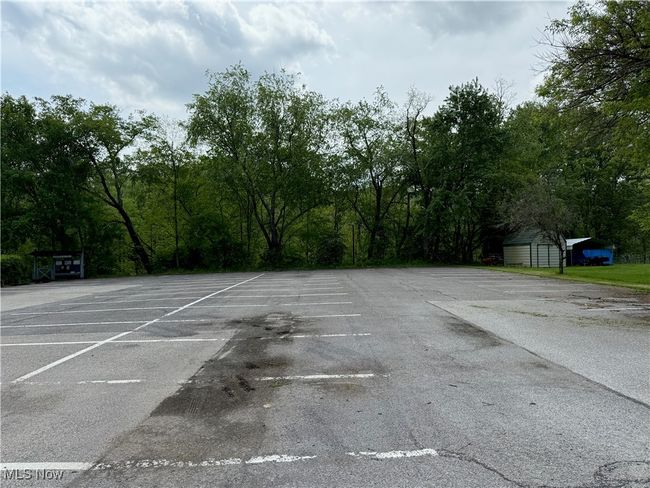 Uncovered parking lot featuring a storage unit | Image 49