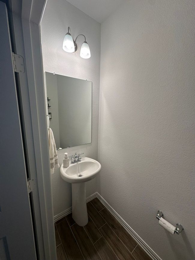 Bathroom featuring wood finish floors and baseboards | Image 17