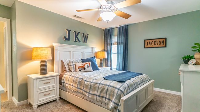 Bedroom with ceiling fan, light colored carpet, baseboards, and visible vents | Image 23