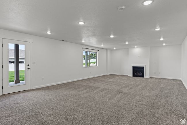Unfurnished living room with recessed lighting, carpet flooring, a fireplace, and baseboards | Image 30