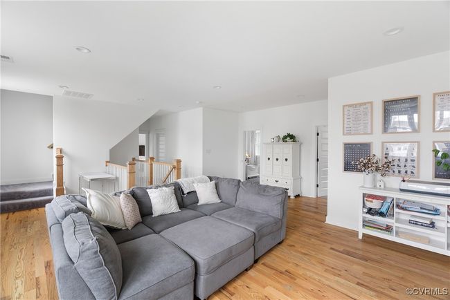 Living area with light wood-type flooring and recessed lighting | Image 24