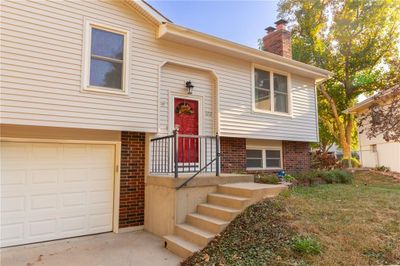 Back of house featuring a wooden deck and a yard | Image 2