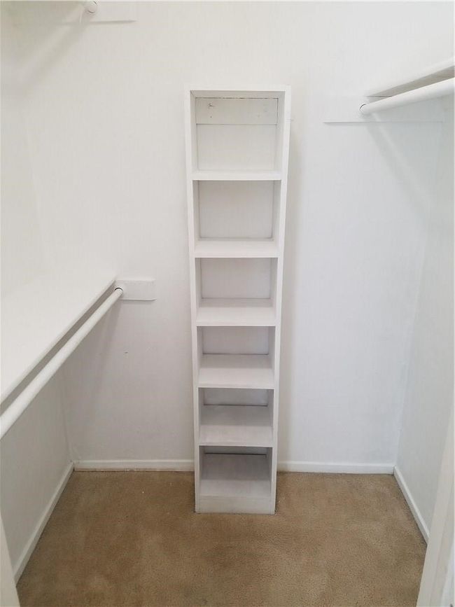 Spacious closet with carpet floors | Image 7