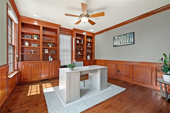 First floor den with hard wood floors and custom shelving | Image 5