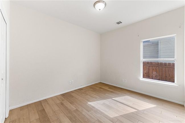 Empty room featuring light wood-style floors and baseboards | Image 30