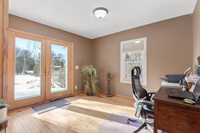 This area has french doors leading to the front patio area with beautiful perennials. | Image 17