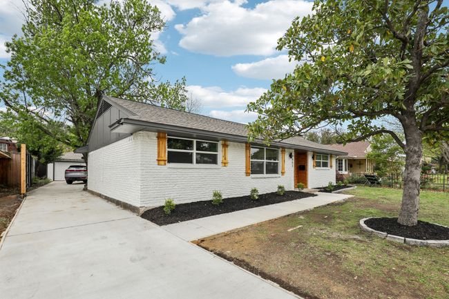 Ranch-style house featuring brick siding, fence, a shingled roof, and an outbuilding | Image 28
