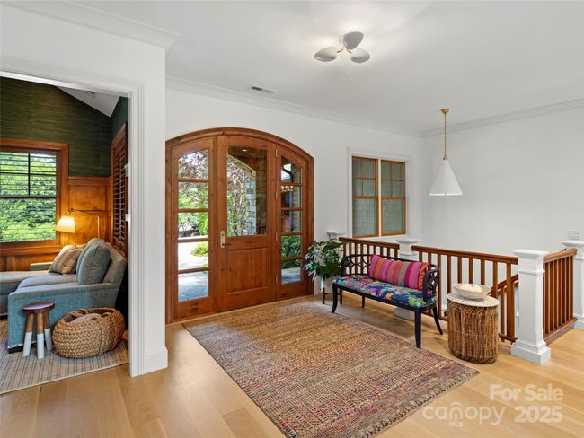 Welcoming, bright and spacious entry with a peek into the private den on the left. | Image 6