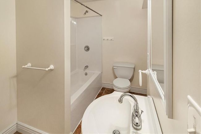 Bathroom with shower / bath combination, baseboards, and toilet | Image 38
