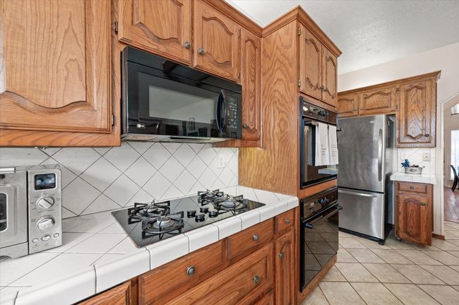 Kitchen offers gas cooktop and double ovens for easy meal preparations. When you tour, don't miss the large pantry to store all of your canned and dry goods! | Image 28