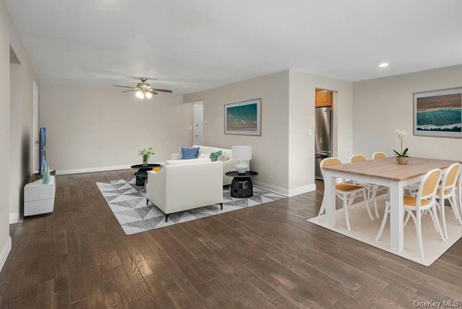 Living room with wood finished floors, baseboards, a ceiling fan, and recessed lighting | Image 6