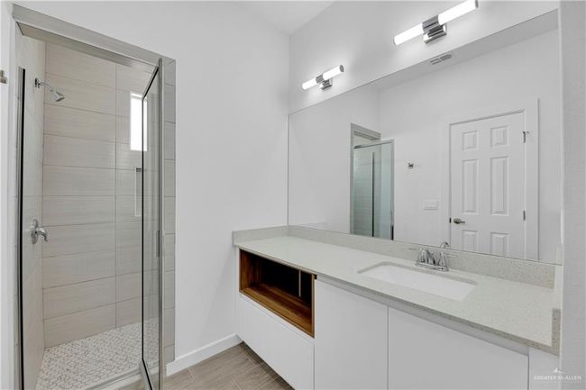 Bathroom with vanity, wood-type flooring, and a shower with shower door | Image 9