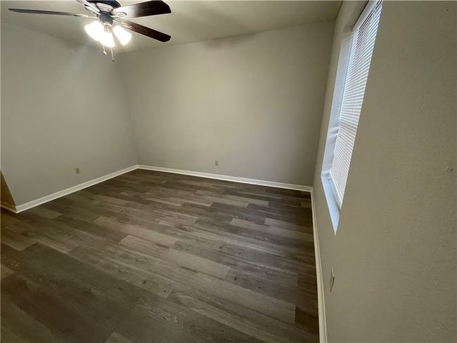 Spare room featuring ceiling fan and dark hardwood / wood-style flooring | Image 8