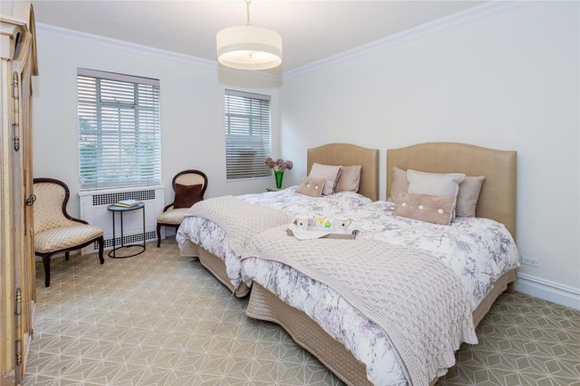 Bedroom featuring crown molding and radiator heating unit | Image 16