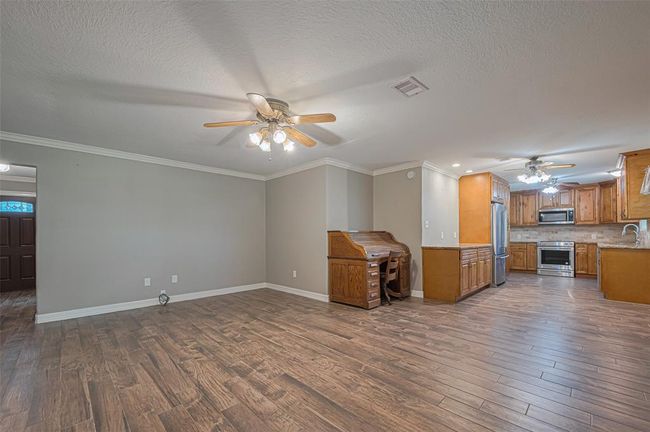 Large living area flows freely into dining area and kitchen, perfect for entertaining or family gatherings | Image 7