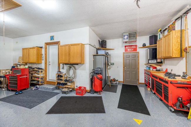To the left is the laundry/mud room entry, and to the right is the door to the wrap around deck. | Image 47