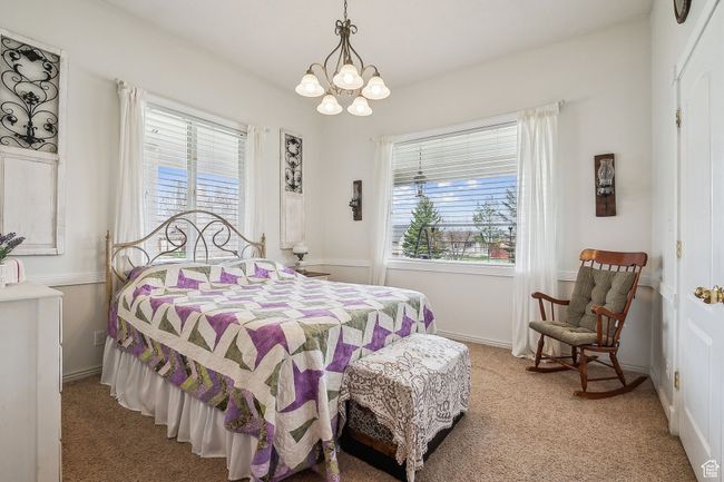 Bedroom featuring a notable chandelier and light carpet | Image 31