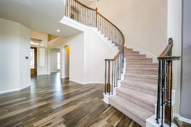 Lush carpeting and the visual beauty of the builder's signature wrought iron staircase, ensures luxury and safety. | Image 10