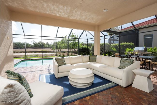 View of patio with outdoor lounge area, an outdoor pool, and glass enclosure | Image 12