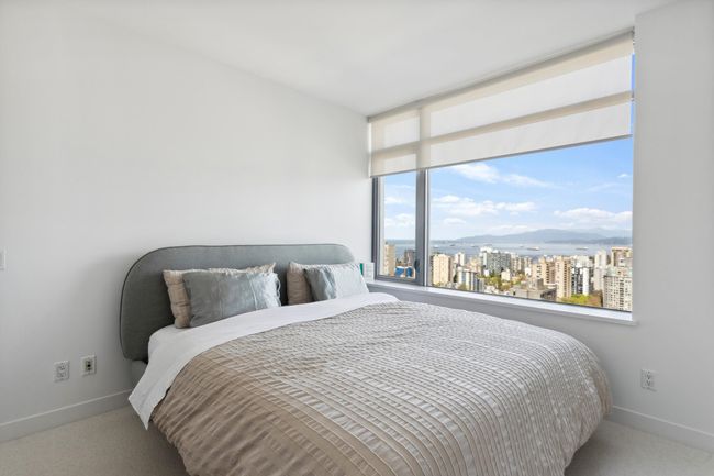 Bedroom with a city view, carpet floors, and baseboards | Image 13