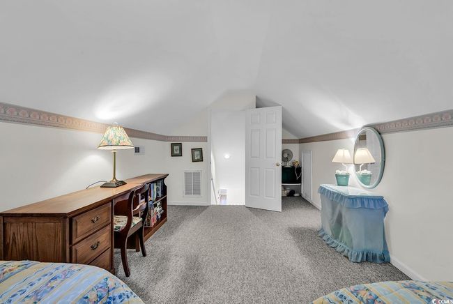 Carpeted bedroom with vaulted ceiling and baseboards | Image 27