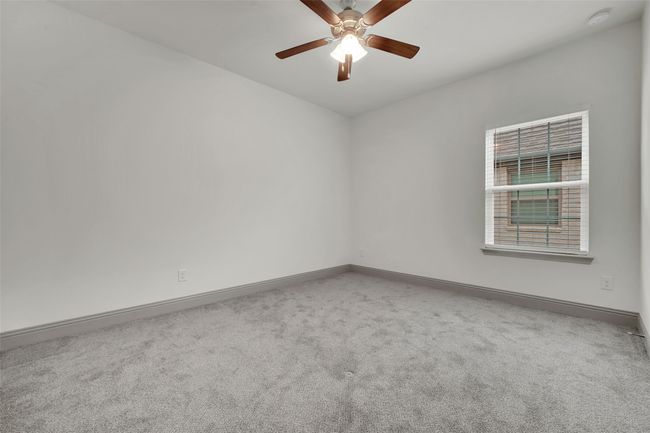 Carpeted empty room featuring baseboards and a ceiling fan | Image 16