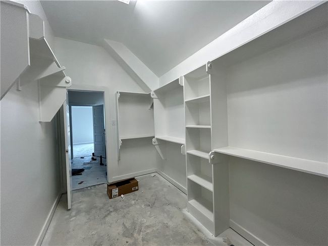 Spacious closet featuring lofted ceiling | Image 11