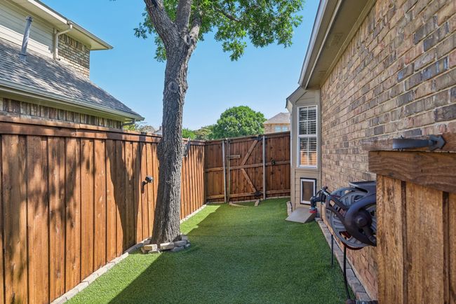 Dog run on the side of the house. Dog door located in the kitchen. | Image 34