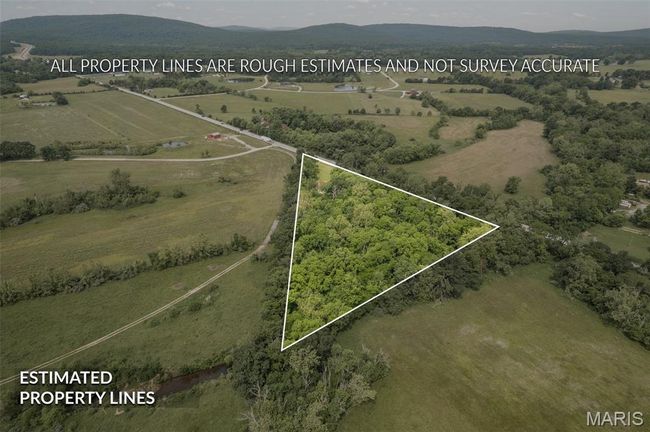 View of rural area with property boundaries highlighted and a mountainous background | Image 47