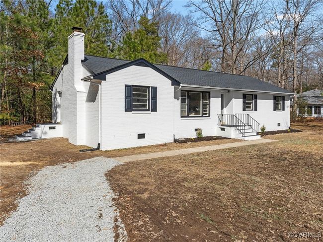 Ranch-style house featuring crawl space, roof with shingles, a chimney, and brick siding | Image 38