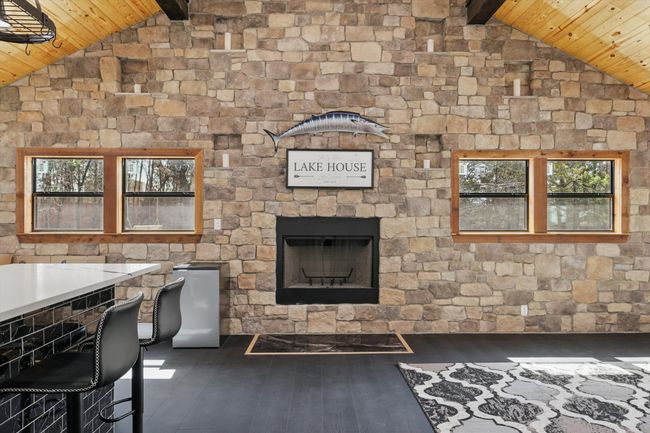 Unfurnished living room featuring lofted ceiling with beams, wooden ceiling, and wood finished floors | Image 6