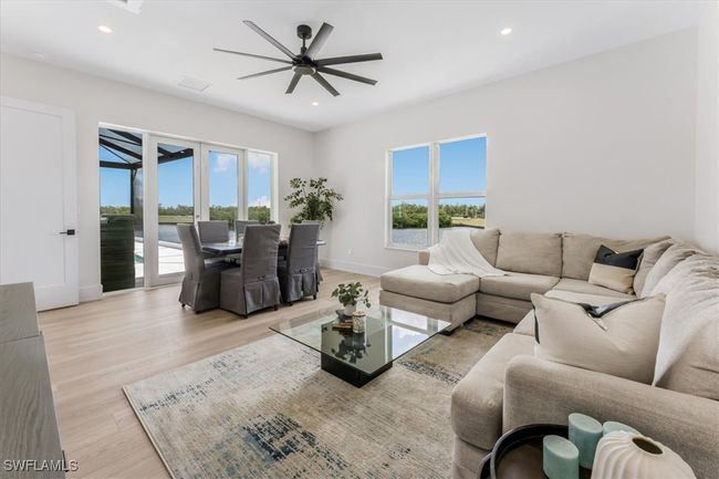 Living area featuring light wood-type flooring, a ceiling fan, and recessed lighting | Image 22
